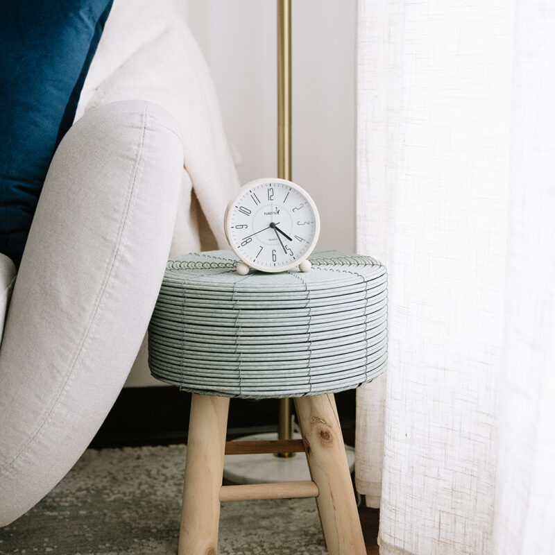 Cozy therapy room corner with a chair, side table, and clock at The Mindful Place in Cambridge Ontario.