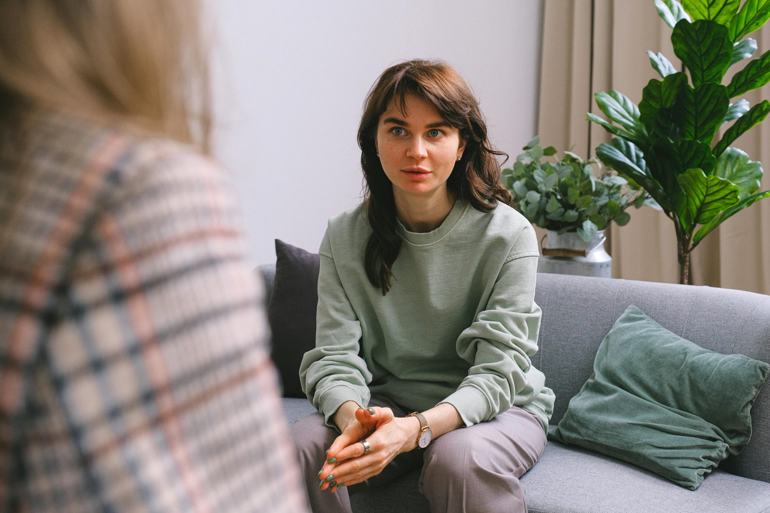 A therapist listens attentively to a client during a supportive session focused on building self-worth, confidence, and healthy boundaries.