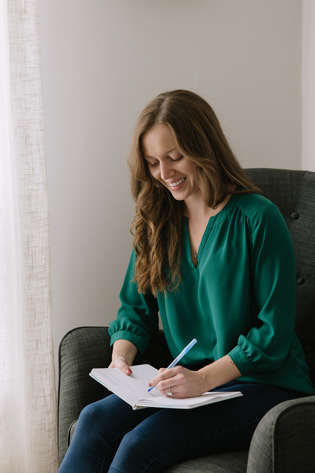 Therapist sitting calmly and writing in a notebook, symbolizing mindfulness, reflection, and strategies for managing anxiety, as discussed in The Mindful Place’s presentations in Ontario.