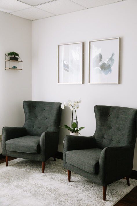 Therapy room at The Mindful Place in Cambridge Ontario with comfortable green chairs and calming decor.