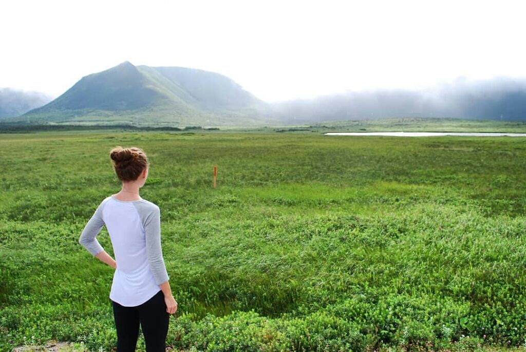 Chantale standing calmly in a green field, practicing mindfulness and grounding techniques for nervous system regulation at The Mindful Place in Ontario.